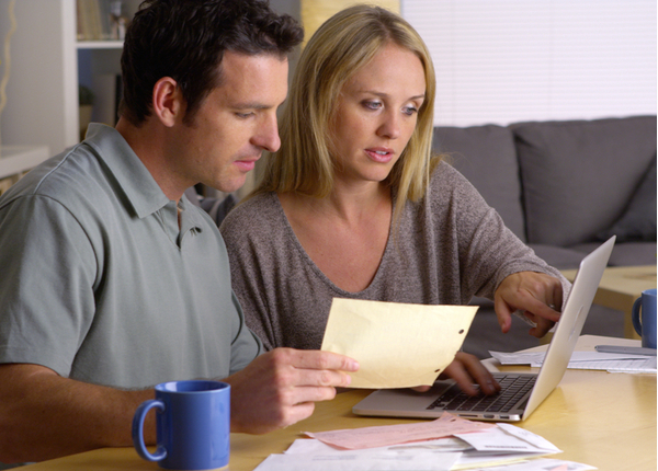Couple doing their finances with laptop