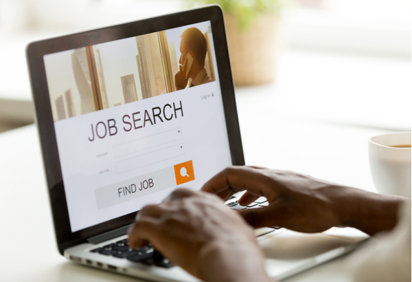 Man browsing work opportunities online using job search computer app