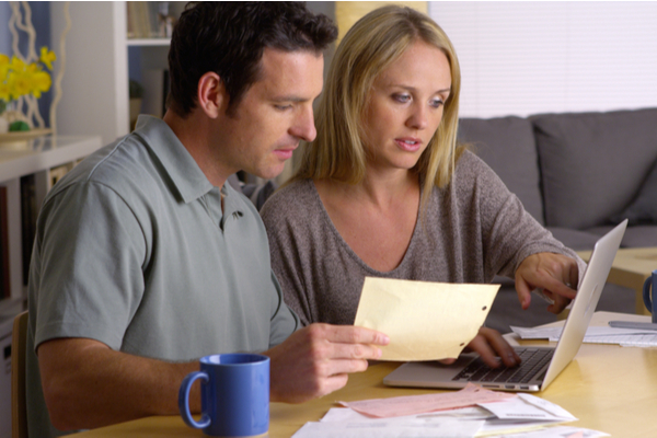 Couple checking finances on the laptop