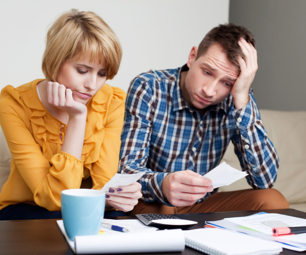 Sad and Depressed partners looking at the bills