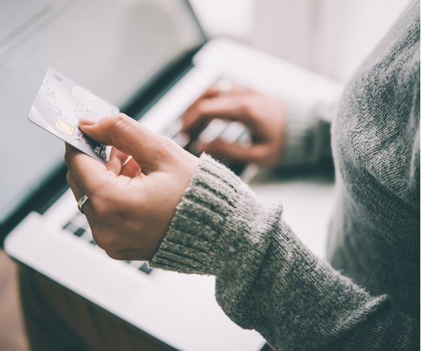 SU - Hands holding plastic credit card and using laptop Hands holding plastic credit card and using laptop