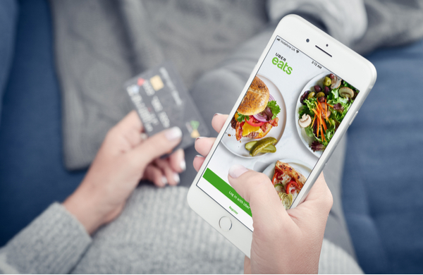 SU - Woman using uber eats app on Mobile Woman using uber eats app on Mobile