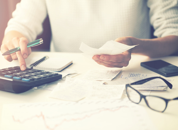 SU - Woman calculating bills at home Woman calculating bills at home
