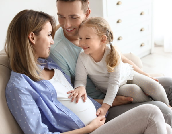 Young pregnant woman with her family