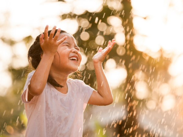 Happy kid playing in the rain