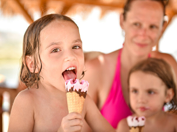 Children eating ice cream after swimming