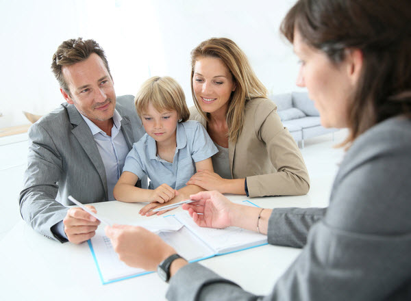 Parents with young boy meeting with an agent
