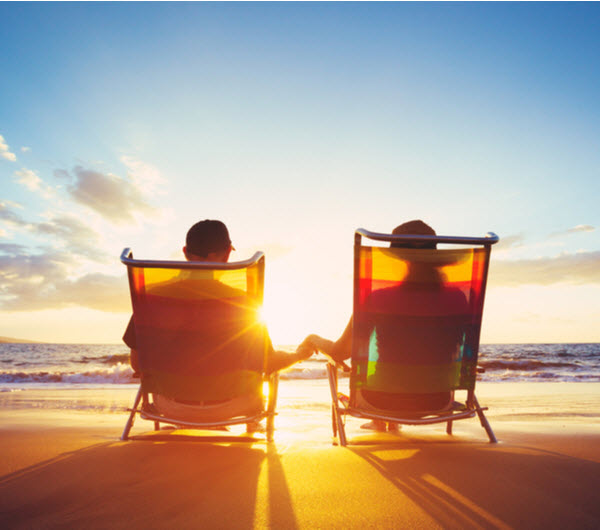 Step Up - Thinking about retirement Couple enjoying the beautiful sunset at the beach