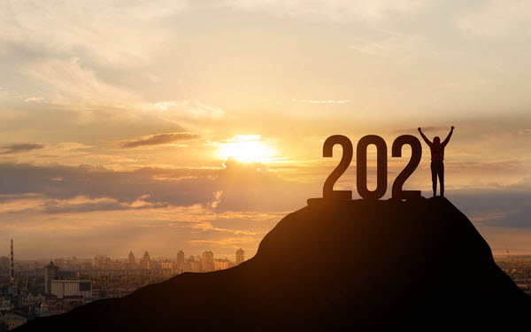 Step Up Group - Year in review Man standing on top of a mountain completing a number of 2021