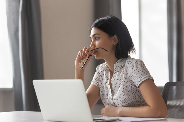 woman looking away thinking solving problem at work