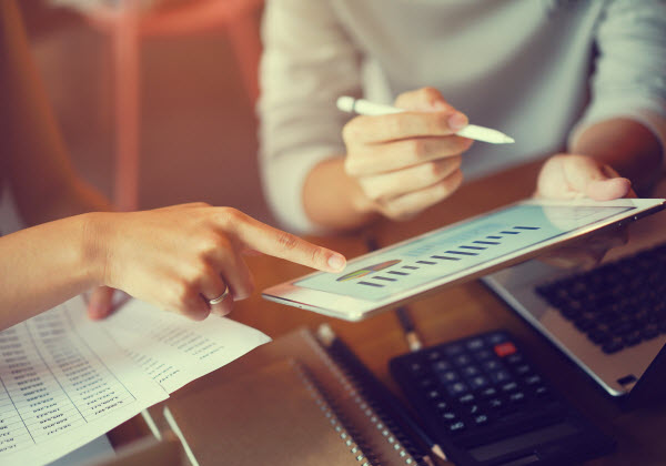 Step Up Group - Measuring performance super fund businesswoman hand point on dashboard screen tablet device for ask and consulting with businessman partner