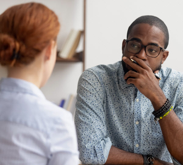 Step Up Group - Investors invest in Queensland property Serious man listening to the lady in front of him