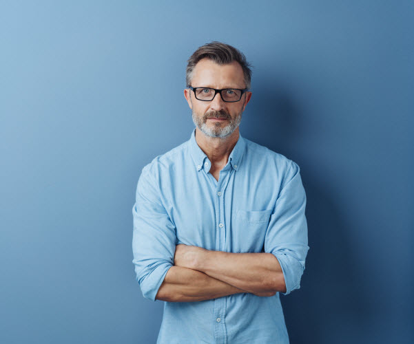 Step Up Group - Queensland land tax question Serious authoritative bearded middle-aged man with folded arms standing