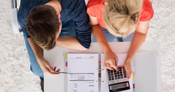 Step Up Group - Restructure debt Couple Using Calculator For Calculating Invoice, Tax, Bills