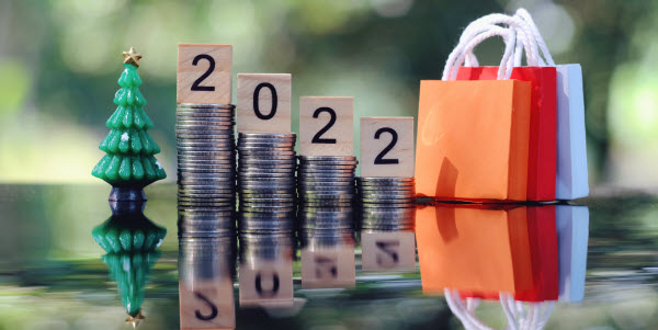 Step Up Group - Budgeting for festive season wooden text block, toy pine tree and small bag on table, saving and manage money for holiday season business, holiday concept