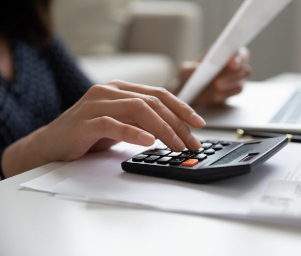 Step Up Group - Monthly budget review woman calculating domestic expenses