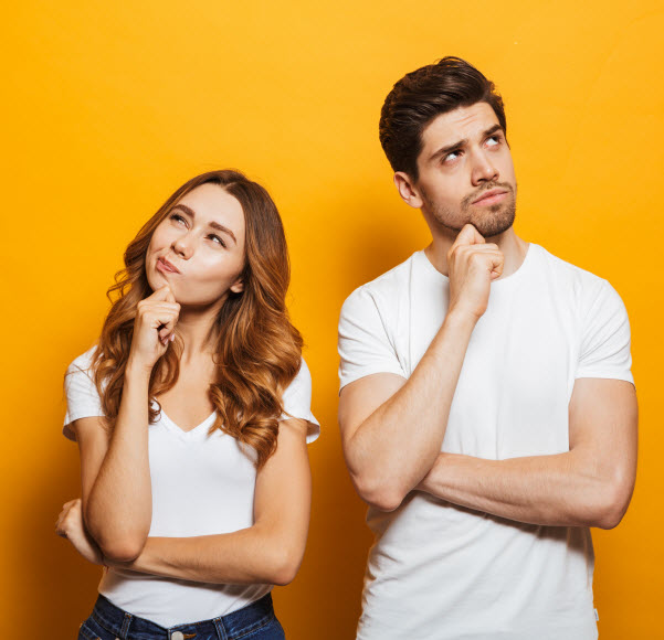 happy young people man and woman in basic clothing thinking and touching chin while looking aside