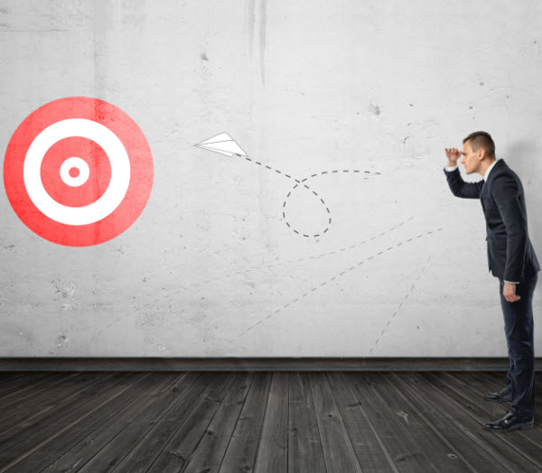 Businessman keeping track of the paper airplane flying right on target