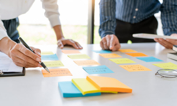 business workers posting with sticky notes stickers reminders creative brainstorming