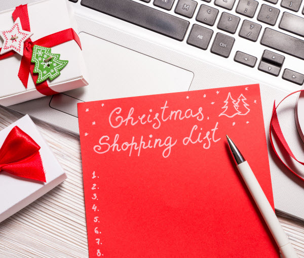 Step Up Group - Christmas ideas plan Christmas Shopping list on top of the laptop