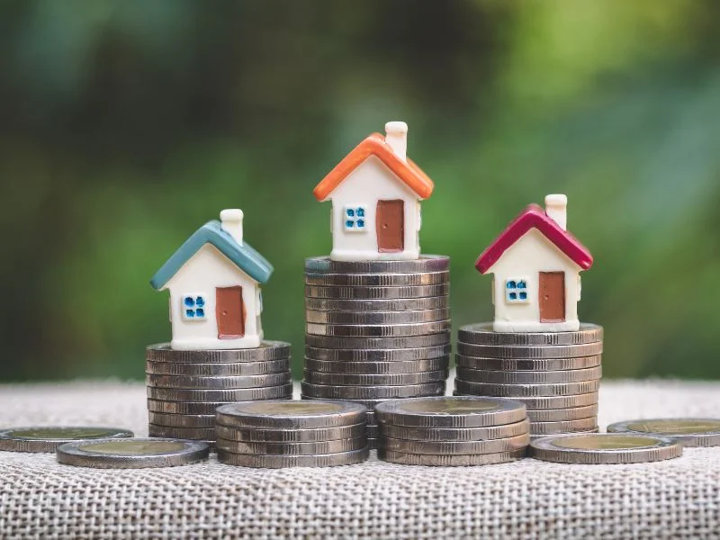 Mini house on stack of coins, Concept of Investment property