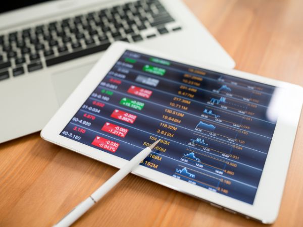 Step Up - Financial advisors offer support and guidance Digital tablet with stock market data