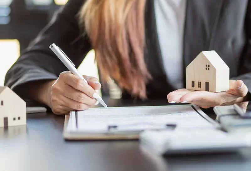 Female woman hands holding home model