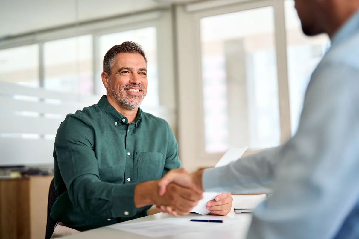 Men smiling while shaking hands