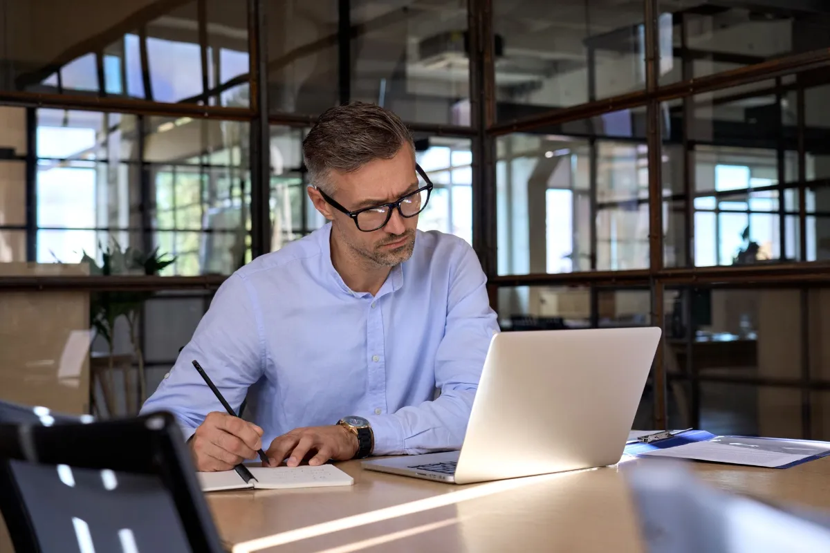 Professional man is working while looking at the Laptop